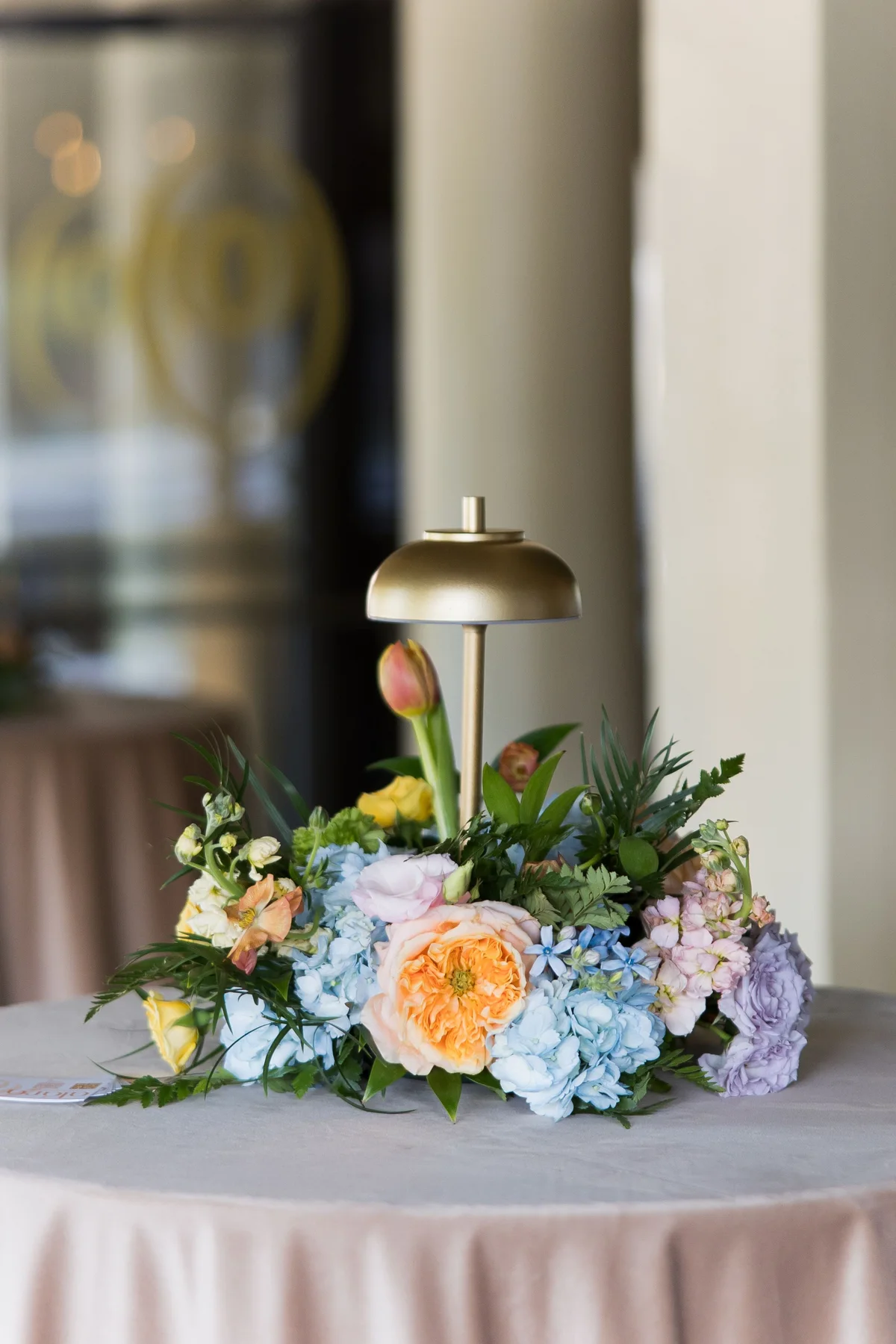 Flowers and warm lamplight at an Alára table